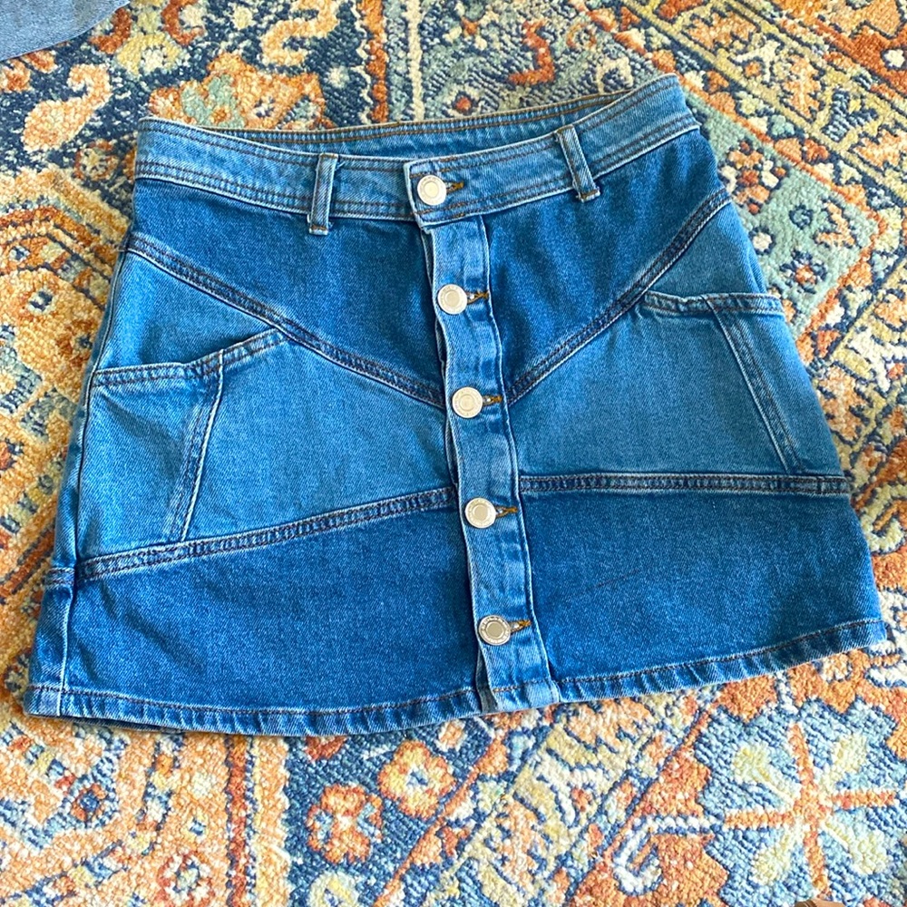 So branded jean skirt with buttons and pockets. Size 7.